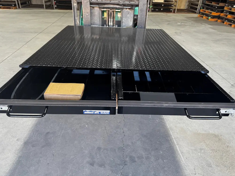 Black truck bed storage box showing multiple drawers.
