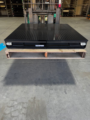Black truck bed storage box with closed drawers.