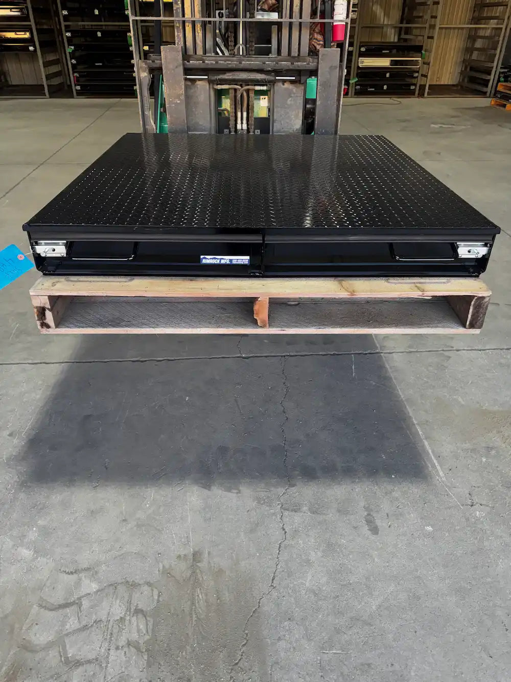 Black truck bed storage box with closed drawers.