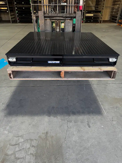 Black truck bed storage box with closed drawers.