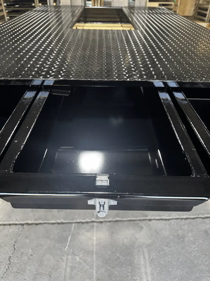 Black truck bed storage system with several pull‑out drawers.