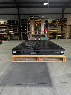 Black truck bed drawer system with open storage compartments.