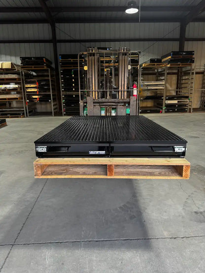 Black truck bed drawer system with open storage compartments.