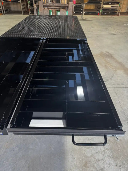 Black truck bed storage system with a right‑hand drawer extended.