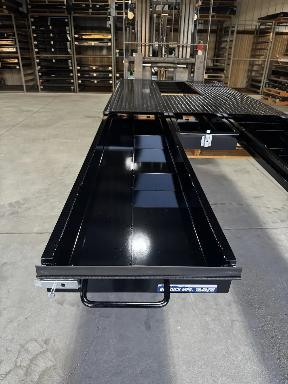 Black truck bed storage with a left‑hand drawer extended.