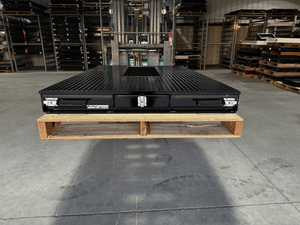 Black truck bed drawer system with open storage compartments.