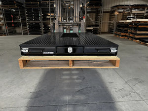 Black truck bed drawer system with open storage compartments.